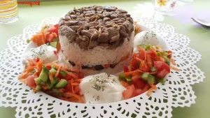 Maklube with lamb, rice and salad